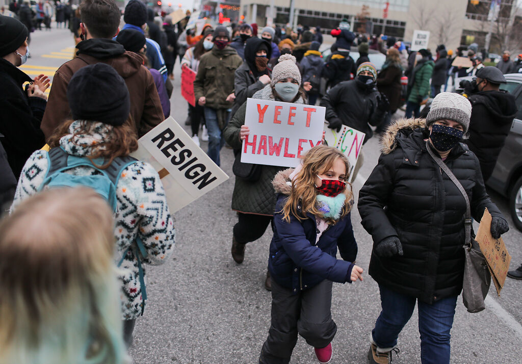 Shana Blumenthal from St. Louis, right, dances with her daughter Sophia Schmittgens, center, in a soul train line